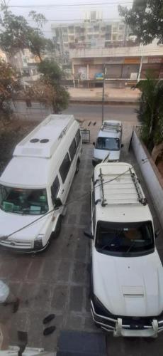 a group of vehicles parked in a parking lot at Swanky Sojourns Cosy Home Stay in Kolhapur