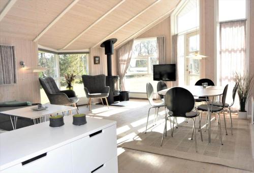 a living room with a table and chairs at 80153-Vemb-Knudehus-49 in Lillelund
