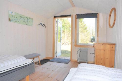 a bedroom with a bed and a large window at 80153-Vemb-Knudehus-49 in Lillelund