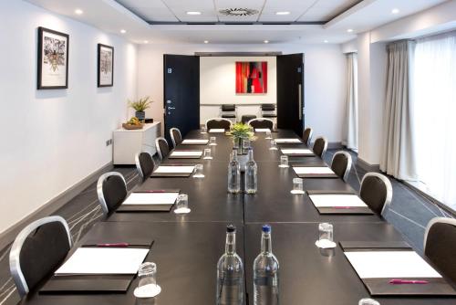 a conference room with a long table with wine bottles at Crowne Plaza Manchester City Centre by IHG in Manchester
