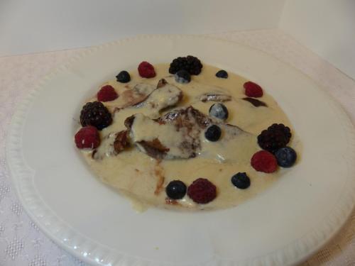 a white plate with a dessert with berries on it at Hotel Vall d´Aneu in Esterri d'Àneu