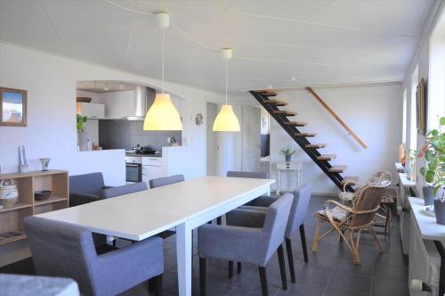 a kitchen and dining room with a white table and chairs at 70029-Ulfborg-Vesterhavsgade-6 in Thorsminde