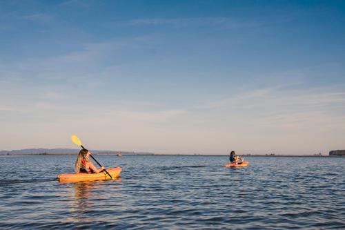 two people in kayaks on a body of water at Chalets du bout du monde in Gaspé