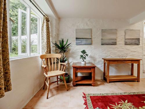 a room with a chair and a table and a window at 3 Bed in Machynlleth 93083 in Cemmaes
