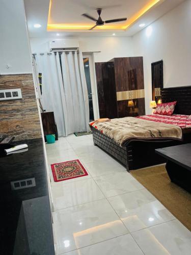 a bedroom with a bed and a ceiling fan at Galaxy royal studio 1 in Noida