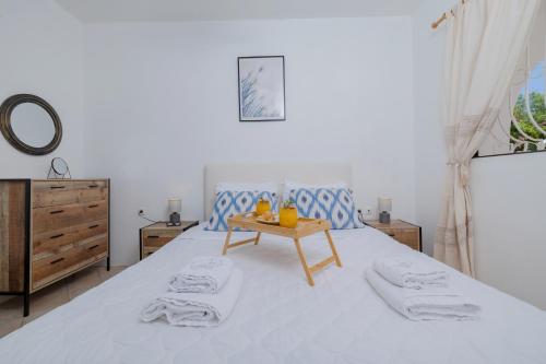 a bedroom with a bed with a table on it at Eco Beach And Magic Garden Hotel in Gennadi