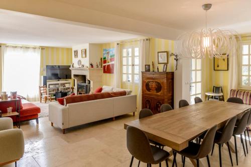 a living room with a table and a couch at Family Home in the Heart of the Luberon with Swimming Pool and Panoramic Vi in Mérindol