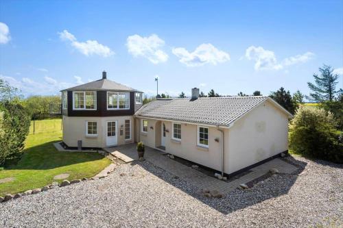 a small white house in a gravel yard at 30876-Ulfborg-Krogsgardvej-5 in Sønder Nissum