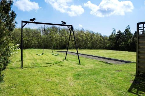 a swing set with two monkeys on it in a field at 30876-Ulfborg-Krogsgardvej-5 in Sønder Nissum