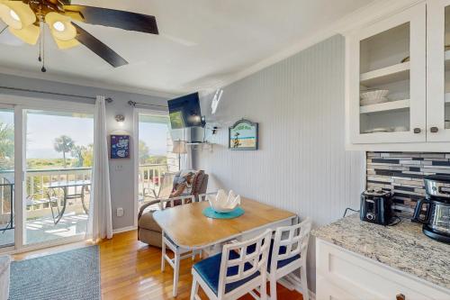 a kitchen and living room with a table and a dining room at Sea Cabin 228-B in Isle of Palms