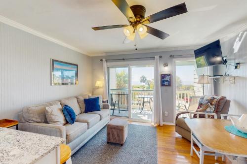 a living room with a couch and a ceiling fan at Sea Cabin 228-B in Isle of Palms