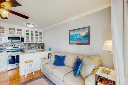 a living room with a couch and a kitchen at Sea Cabin 228-B in Isle of Palms