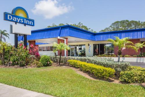 a day inn sign in front of a building at Days Inn by Wyndham Fort Myers Springs Resort in Estero