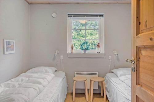 two twin beds in a room with a window at 10843-Ulfborg-Baekbyvej-81 in Øhuse