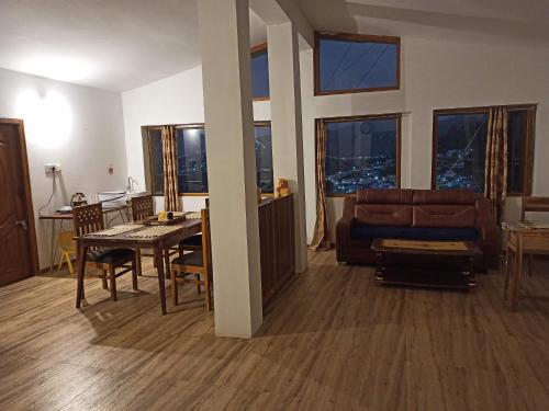 a living room with a couch and a table at Ken valley homes & villa in Lovedale