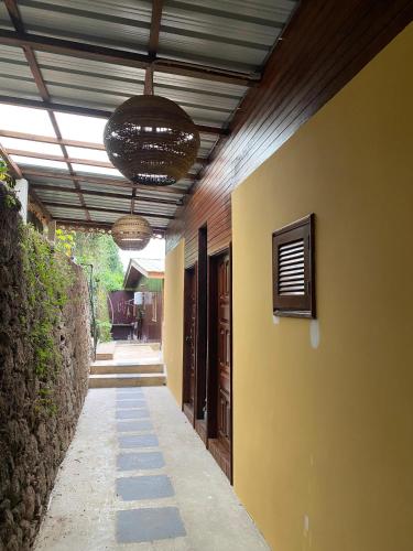 a hallway of a house with two lights on the ceiling at Roça Saudade Guest House in Trindade