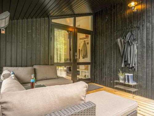 a living room with a couch and a table at Holiday Home Aleida - 400m from the sea by Interhome in Jerup