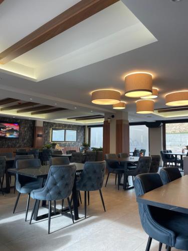 a dining room with tables and chairs in a restaurant at Evergreen Lux in Kopaonik