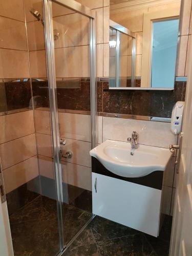 a bathroom with a sink and a shower at Karadeniz Pension in Amasra