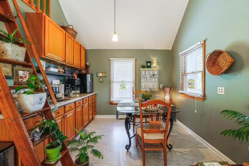 a kitchen with a table and a dining room at Unique and Artistic Retreat Near Rehoboth Beach! in The Plantations