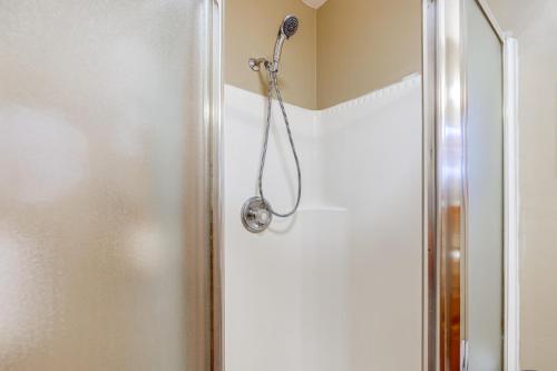 a shower with a shower head in a bathroom at Unique and Artistic Retreat Near Rehoboth Beach! in The Plantations
