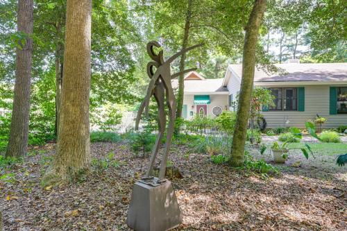 a statue of a pair of scissors in front of a house at Unique and Artistic Retreat Near Rehoboth Beach! in The Plantations