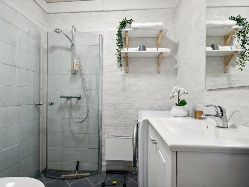 a bathroom with a shower and a sink and a toilet at Holiday Home Barni - 7km from the sea by Interhome in Ebeltoft