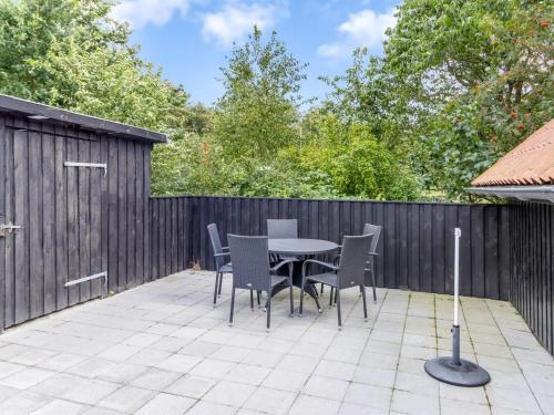 a patio with a table and chairs and a fence at Holiday Home Engelbertine - 30km from the sea by Interhome in Toftlund