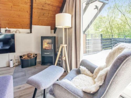 a living room with a chair and a fireplace at Holiday Home Engelbertine - 30km from the sea by Interhome in Toftlund