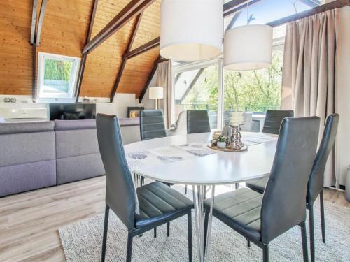 a dining room with a white table and chairs at Holiday Home Engelbertine - 30km from the sea by Interhome in Toftlund