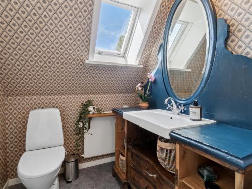 a bathroom with a sink and a mirror at Holiday Home Frederikke - 300m from the sea by Interhome in Gudhjem