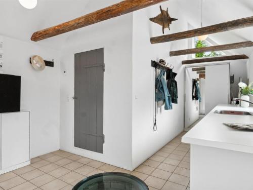 a kitchen with white walls and a door at Holiday Home Keyla - 2-3km from the sea by Interhome in Humble