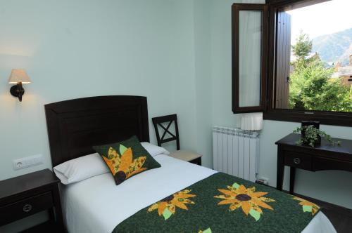 a bedroom with a bed and a window at Casa Rural La Comella in Tirvia