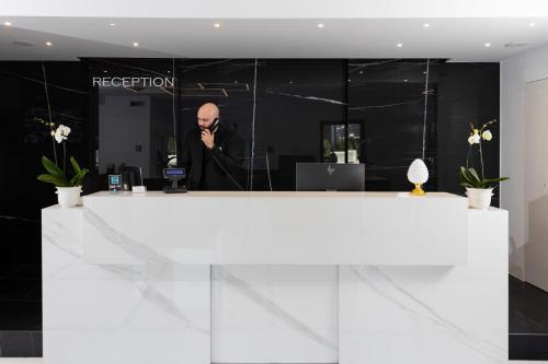 a man standing in front of a reception desk at Eurogarden Hotel in Rome