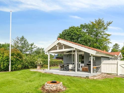 a house with a patio and a yard at Holiday Home Salvina - 300m from the sea by Interhome in Odder