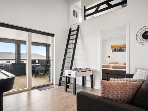 a living room with a staircase and a bed at Holiday Home Alka - 500m from the sea by Interhome in Sjølund
