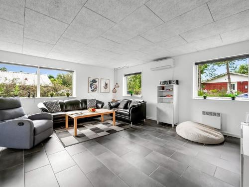 a living room with couches and a table at Holiday Home Amine - 300m to the fjord by Interhome in Skjern