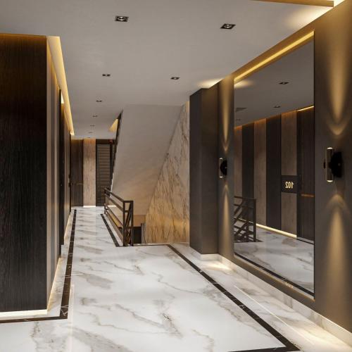 a hallway of a hotel with marble floors and walls at Zee99Arcade in Lahore