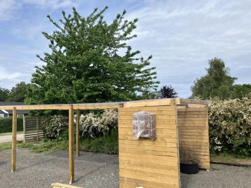 a wooden out house with a window on it at Holiday Home Ion - 250m from the sea by Interhome in Vordingborg