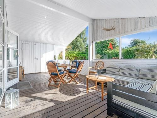 a living room with a couch and a table at Holiday Home Ion - 250m from the sea by Interhome in Vordingborg