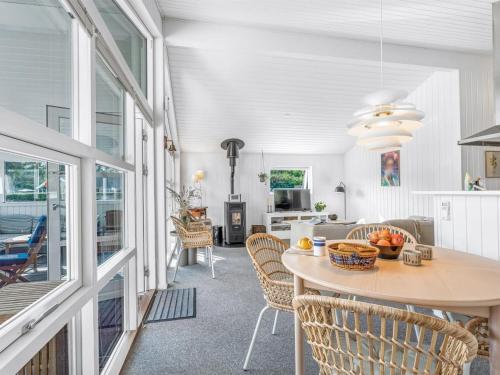 a kitchen and living room with a table and chairs at Holiday Home Ion - 250m from the sea by Interhome in Vordingborg