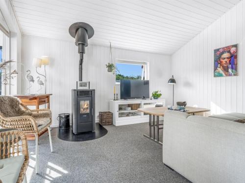 a living room with a couch and a fireplace at Holiday Home Ion - 250m from the sea by Interhome in Vordingborg