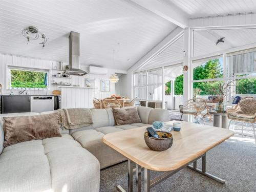 a living room with a couch and a table at Holiday Home Ion - 250m from the sea by Interhome in Vordingborg