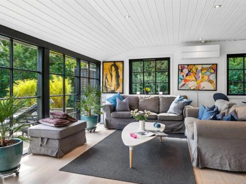 a living room with a couch and a table at Holiday Home Bedine - 1-3km from the sea by Interhome in Gilleleje