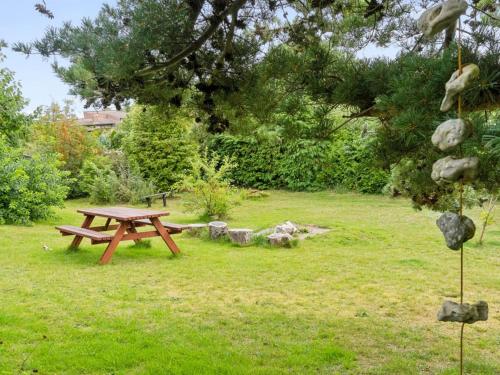 a picnic table in the grass in a park at Holiday Home Yardila - 1-4km from the sea by Interhome in Tisvildeleje
