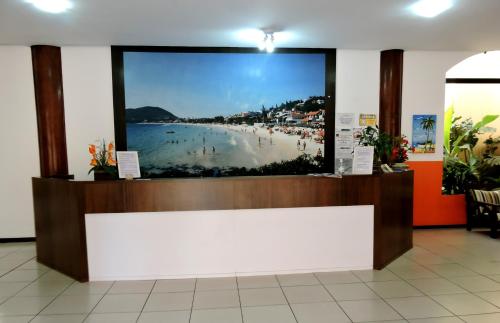 a store with a large picture of a beach at HsHotelaria - Filial Bombinhas in Bombinhas