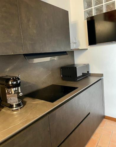 a kitchen with a sink and a microwave on a counter at Suite San Martino in Gubbio