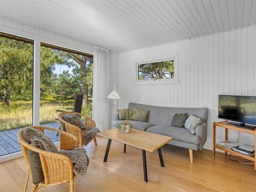 a living room with a couch and a table at Holiday Home Dagny - 520m from the sea by Interhome in Læsø
