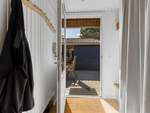 an open door to a deck with a patio at Holiday Home Dagny - 520m from the sea by Interhome in Læsø