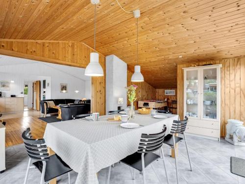 a dining room and living room with a table and chairs at Holiday Home Hansiane - 80m from the sea by Interhome in Strøby